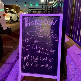 a chalkboard sign on a sidewalk