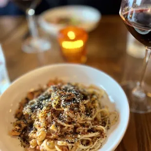a plate of pasta and a glass of wine