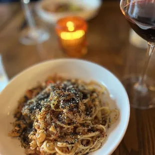 a plate of pasta and a glass of wine