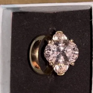 My polished gold band and the replacement center stone they chose.