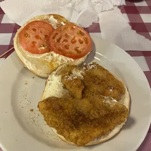 Dressed catfish poor boy. They were out of lettuce so it will usually have lettuce if dressed. On a bun for me.