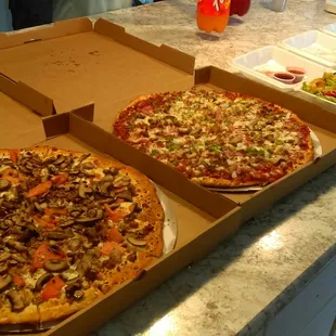 two pizzas in boxes