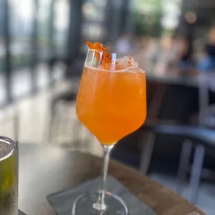 a glass of orange juice on a table