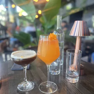 two glasses of alcohol on a wooden table