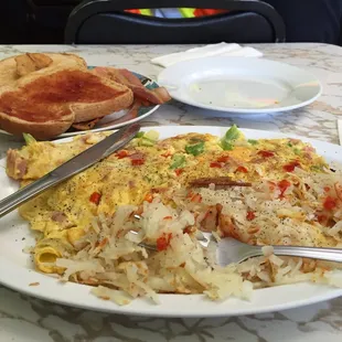 Denver omelette with cheese, hash browns and of course hot sauce!