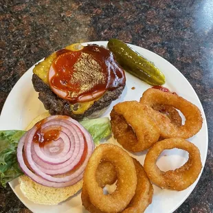 a hamburger and onion rings