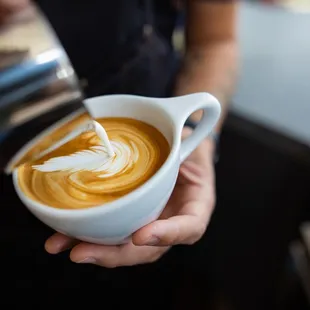 a latte being poured into a cup