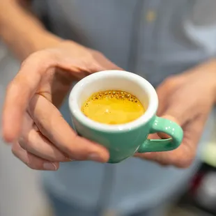 a person holding a cup of coffee