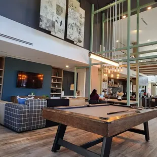 a pool table in the middle of a living room