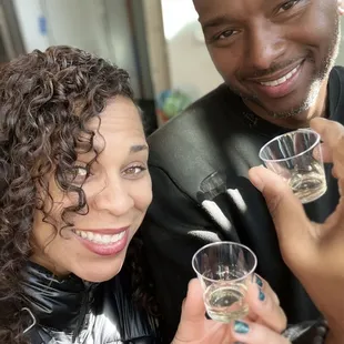 a man and a woman holding glasses