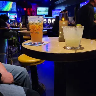 a man sitting at a bar with a drink in front of him