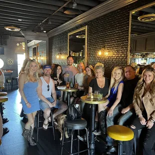 a group of people sitting at a bar