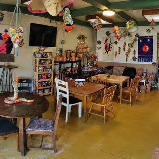 Cozy café with Talavera pottery on shelves and walls.