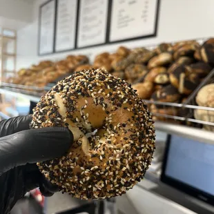 a person holding a bagel