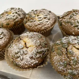 six muffins covered in powdered sugar