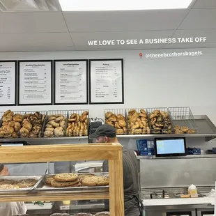 a bakery counter with a variety of pastries