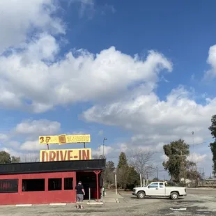 a car parked in front of a drive - in