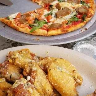 Garlic parmesan wings. In background cheese sausage spinach pizza.  Yummo!