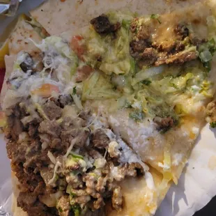 a taco with meat and cheese