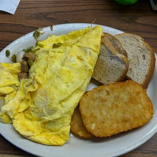 Italian sausage omelette with hash browns and rye toast.