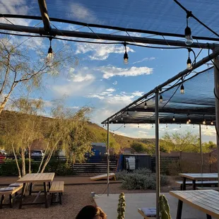 a patio with tables and chairs