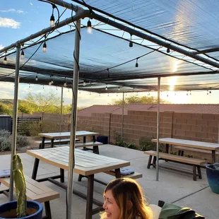 a patio with tables and benches