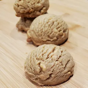 three cookies on a cutting board