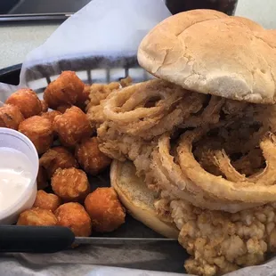 Pork tenderloin sandwich topped with onion rings, and sweet potato mini puffs with marshmallow dipping sauce