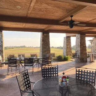 a patio with tables and chairs