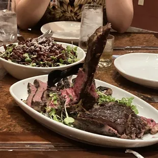 a woman taking a picture of her meal