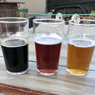 three glasses of beer on a table