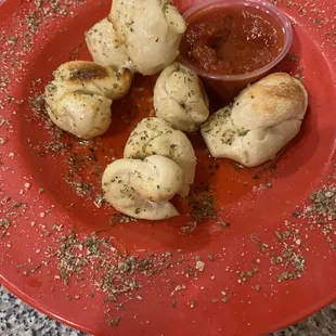 Half eaten plate of Garlic Knots - always delicious