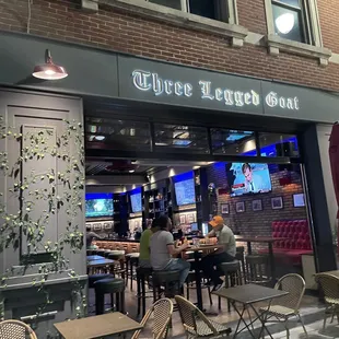 outside of restaurant with tables and chairs