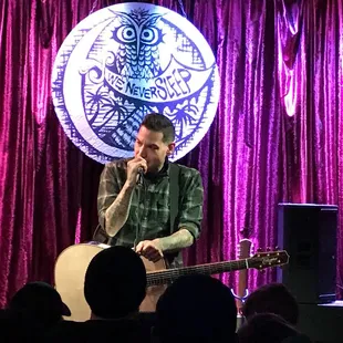 a man singing on stage