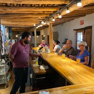 a group of people sitting at a bar