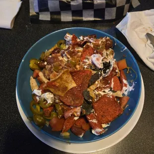 Nachos in a cereal bowl...stale...cold on one side slightly warm on the other...thanks but never again.