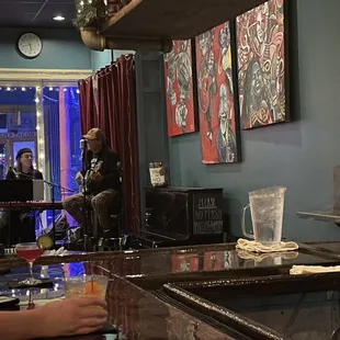a man and a woman sitting at a bar