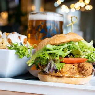 CRAB CAKE SANDWICH: Blue crab cake, lettuce, tomato, remoulade sauce, brioche bun.