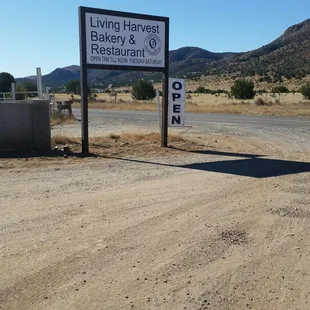 a sign on a dirt road