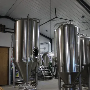 a row of stainless steel tanks