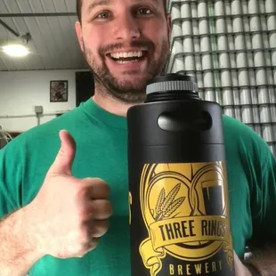 a man holding a bottle of beer