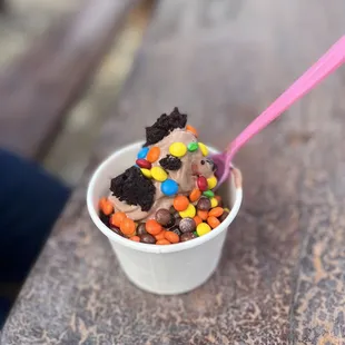 Small chocolate yogurt with brownie bites, mini m &amp; m, and mini Reeses