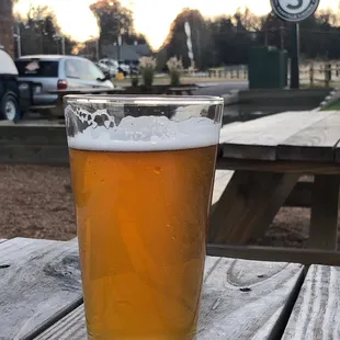 a pint of beer on a picnic table