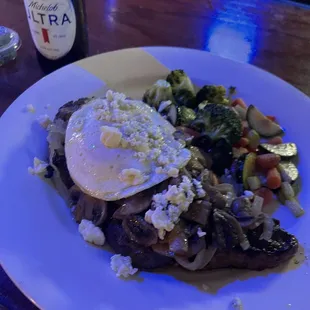 Steak topped with egg, onions, mushrooms and blue cheese. Side of veggies