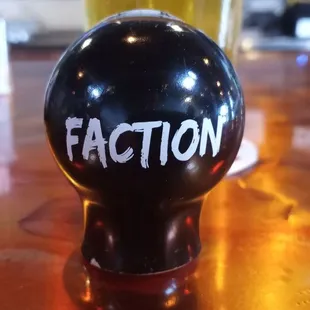 a black ball with the word faction written on it