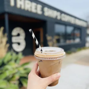 a hand holding a cup of coffee