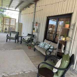 a patio with chairs and tables