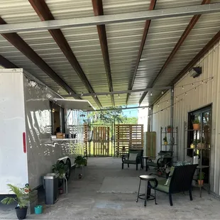 a patio with chairs and tables