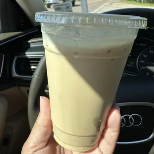 a hand holding a cup of coffee