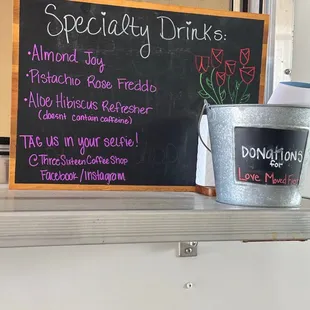 a sign and a bucket of coffee